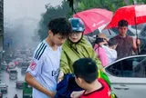 Hà Nội đang nắng gắt bỗng tối sầm, mưa như trút nước giữa trưa khiến người đi đường không kịp trở tay